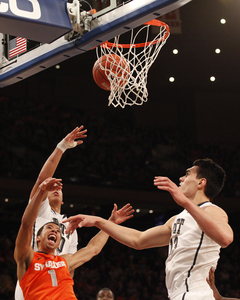 Michael Carter-Williams makes a contested shot inside.