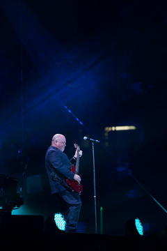 Joel plays a red electric guitar during his first song of the evening, but played most of the show on a rotating piano.