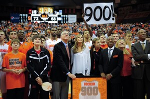 Syracuse head coach Jim Boeheim celebrates his 900th career win with his family, players and coaches. He's only the third coach in Division-I history to reach the milestone.