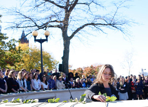 Lockerbie Scholar Megan Noble, lays a rose in memory of Andrew McClune, a former Lockerbie Scholar who passed away at SU.