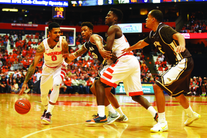 Michael Gbinije dribbles around a screen on Tuesday night. He finished with 23 points against St. Bonaventure.