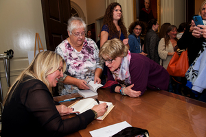 Esther Gray works with SU alumna and author Cheryl Strayed, who spoke as part of the University Lectures on Oct. 17.