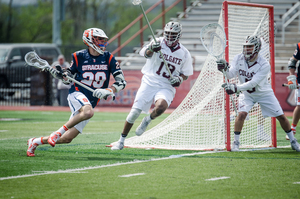 Freshman Stephen Rehfuss emerges from behind the cage in recent action against Colgate. He and the Orange host Yale Sunday at 7:30 p.m.