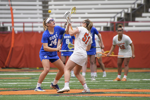 Gary Gait allows his players, like Emily Hawryschuk (right), to string their own sticks. But, they all prefer when he does it.