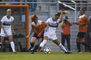 Syracuse midfielder Georgia Allen, who played her first game of the season on Friday, fights for the ball in last season's matchup with Colgate.