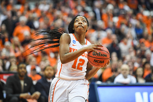 Kiara Lewis holds the ball on the way to the rim.