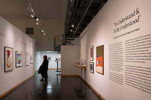 Visitors walk through the gallery of 