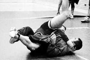 Wrestling club president Tom DeGrocco (in shorts) takes down junior Peter Dolan during a late night practice at Archbold Gym.