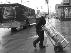 Mark Fancher delivers beer for Spirit & Sanzone Distributing Co. Inc., to Lucy&s Retired Surfers Bar on Thursday afternoon. Many local businesses ordered more beer in anticipation of greater crowds. 