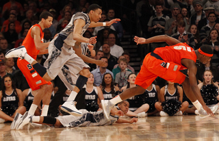 Georgetown's Otto Porter (#22) and C.J. Fair chase after a fumbled ball.