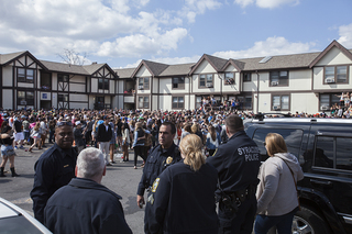 Syracuse Police watch as partiers celebrate at Castle's Court, Friday afternoon.