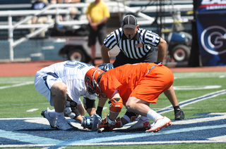 Syracuse's Chris Daddio and Villanova's Thomas Croonquist prepare to fight for a faceoff.