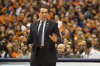 Duke head coach Mike Krzyzewski coaches his players from the sideline. 