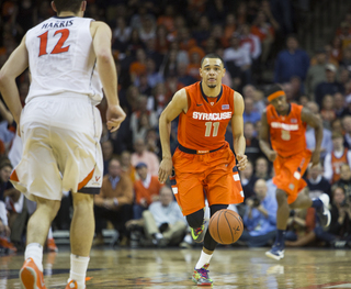 Ennis charges up the court toward Joe Harris who guards the rim. 