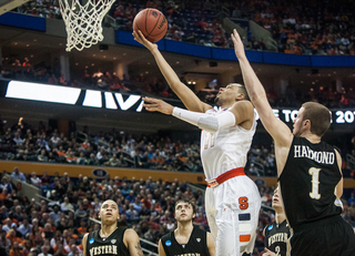 Ennis completes a finger-roll layup with Tucker Haymond a step behind.