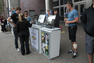 Chevy representatives speak with SXSW visitors about  test driving their vehicles outside the Austin Convention Center on March 14, 2014. Convention attendees had the opportunity to try out Chevy models such as the Volt, Sonic and the all new 2015 Tahoe among others.