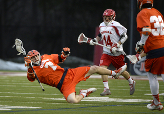 Midfielder Henry Schoonmaker slips while keeping possession of the ball.