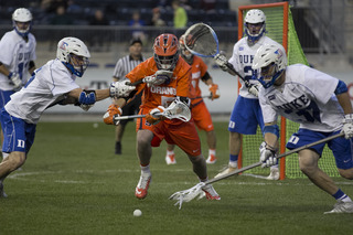 Nicky Galasso looks to pick up a ground ball with multiple Duke defenders around him.