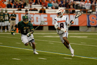 Senior midfielder Hakeem Lecky looks to dodge toward the net while Siena's Jon-Michael Tokar defends.