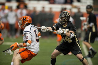 Syracuse midfielder Nicky Galasso looks to make a move on long-stick midfielder Billy Baird.