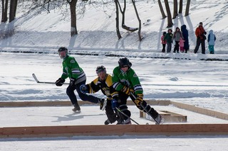 A player blocks their opponent from advancing the score in a morning game at the 2022 Syracuse Pond Hockey Classic. 